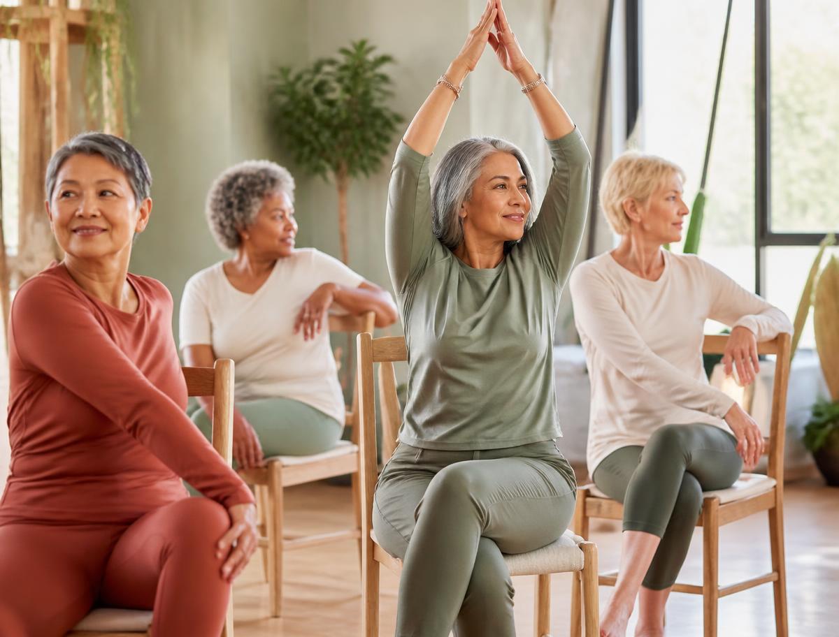 A diverse group enjoying chair yoga together